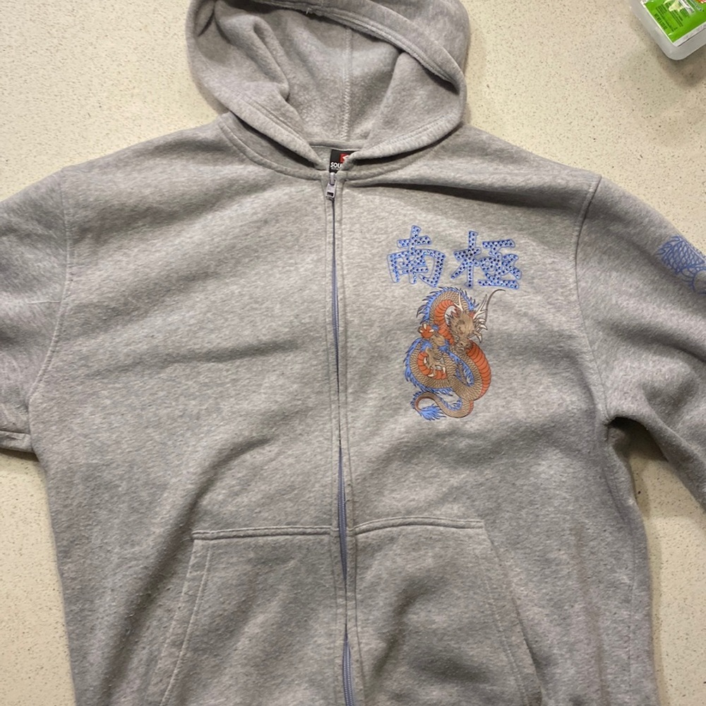 A grey “South Pole” zip up.